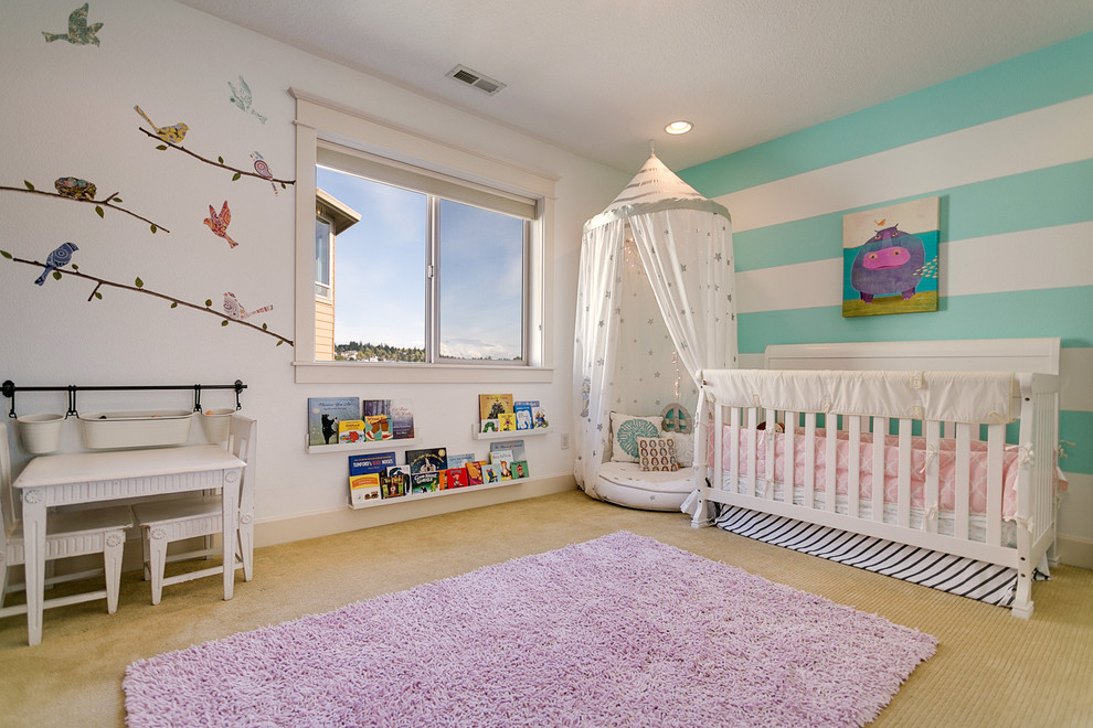 Transitional nursery in Portland with multi-coloured walls, carpet and purple floor for girls.