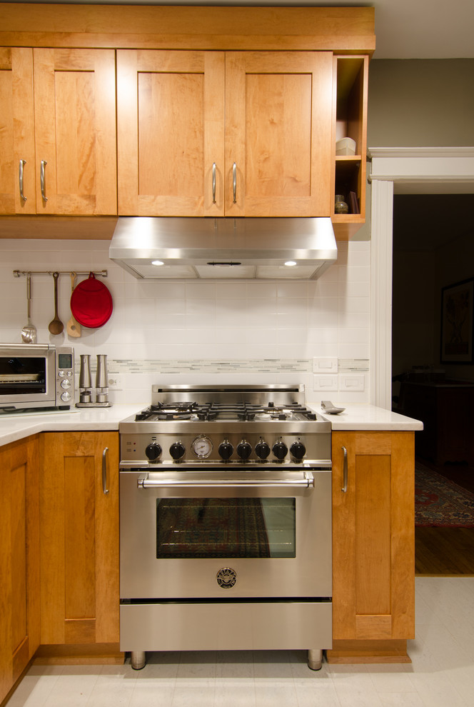 Example of a large transitional l-shaped cork floor eat-in kitchen design in DC Metro with an undermount sink, flat-panel cabinets, quartz countertops, white backsplash, glass tile backsplash, stainless steel appliances and no island