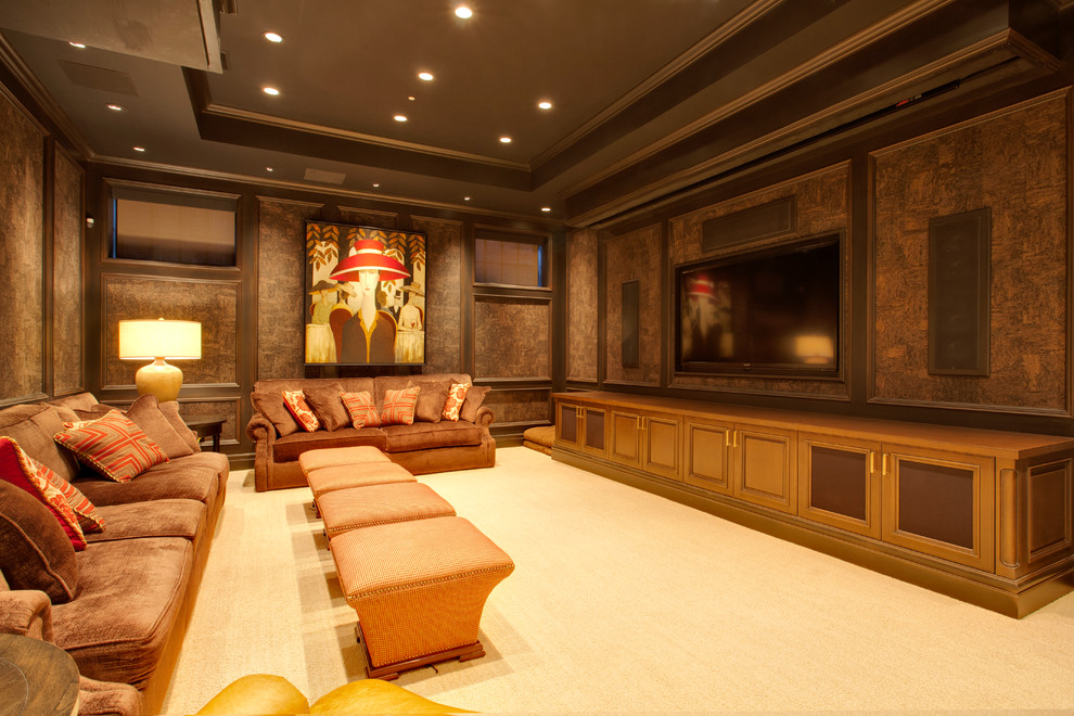 Design ideas for a large traditional open concept home theatre in Calgary with brown walls, carpet, a wall-mounted tv and beige floor.