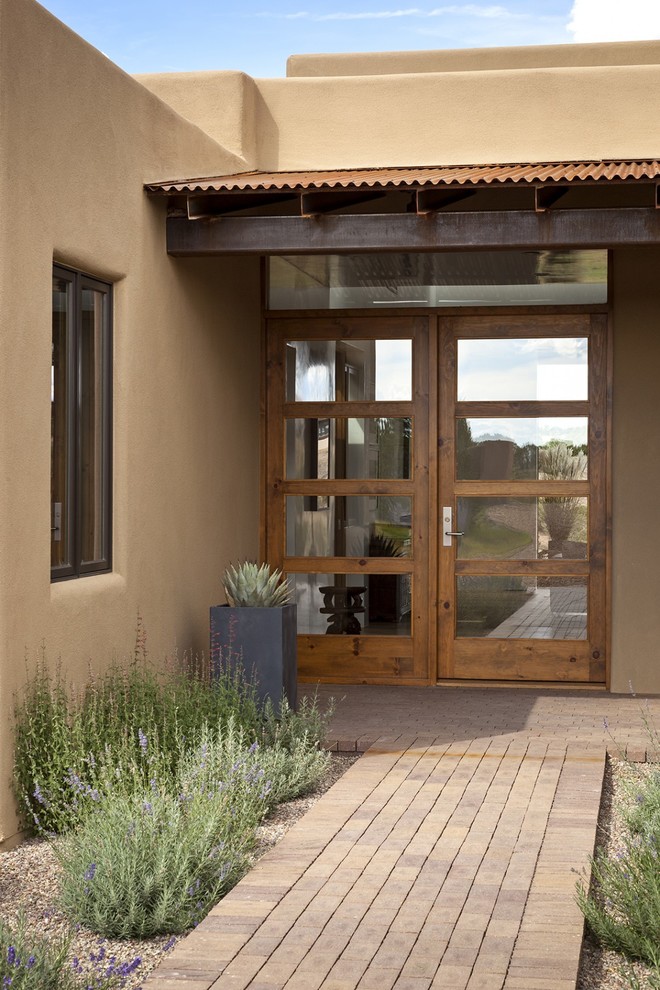 This is an example of a mid-sized contemporary front door in Orange County with a single front door and a glass front door.