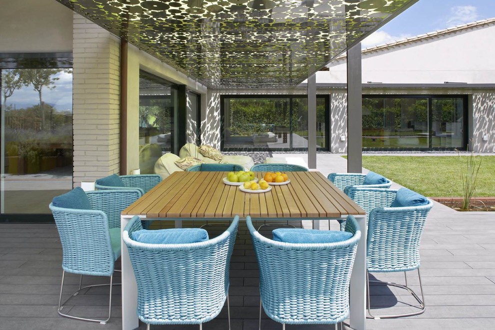 Design ideas for a mid-sized contemporary side yard deck in Other with a pergola.