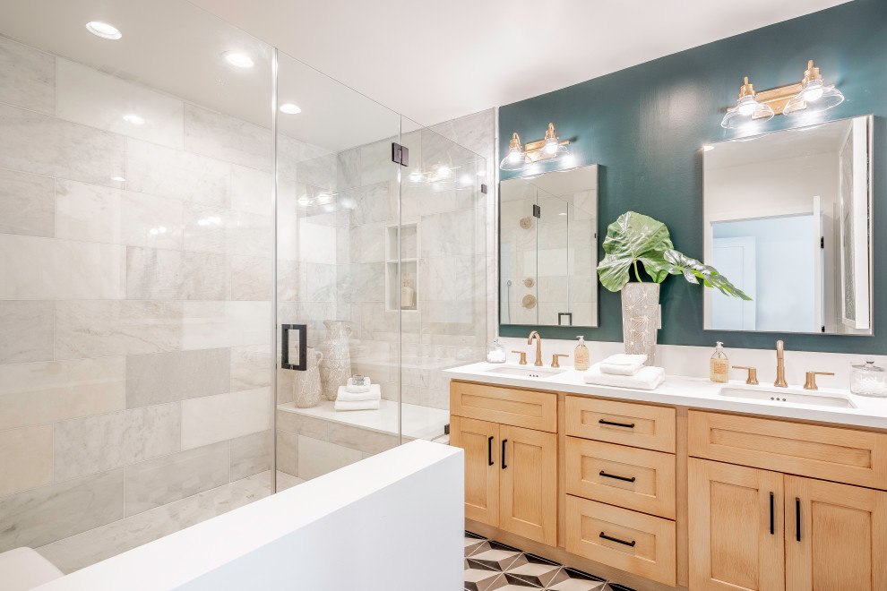 Photo of a mediterranean master bathroom in Los Angeles with shaker cabinets, medium wood cabinets, an alcove shower, gray tile, green walls, an undermount sink, multi-coloured floor, white benchtops and a double vanity.