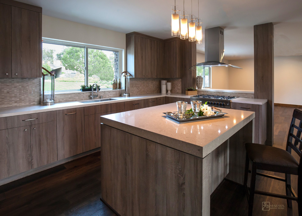 This is an example of a mid-sized contemporary u-shaped open plan kitchen in Santa Barbara with an undermount sink, flat-panel cabinets, medium wood cabinets, quartzite benchtops, beige splashback, stone tile splashback, stainless steel appliances, dark hardwood floors and with island.