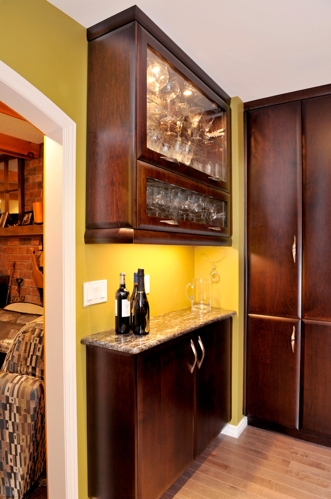 Kitchen - transitional dark wood floor kitchen idea in Toronto with a double-bowl sink, flat-panel cabinets, dark wood cabinets, granite countertops, mirror backsplash, stainless steel appliances and an island