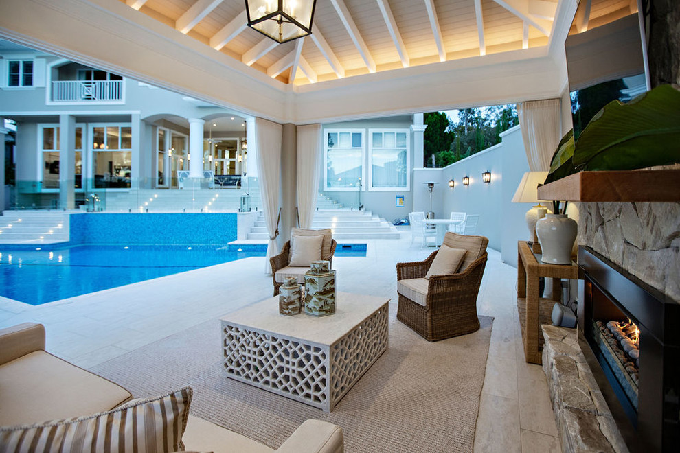 Inspiration for an expansive traditional backyard patio in Gold Coast - Tweed with an outdoor kitchen, natural stone pavers and a roof extension.