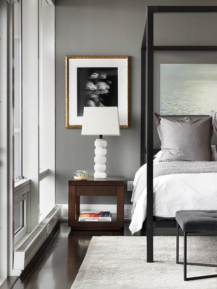 Photo of a contemporary bedroom in Chicago with grey walls, dark hardwood floors and brown floor.