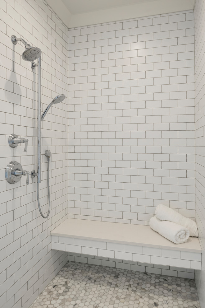 Design ideas for a mid-sized transitional master bathroom in Minneapolis with an open shower, white tile, white walls, marble floors, white floor, an open shower, shaker cabinets, white cabinets, a freestanding tub, ceramic tile, marble benchtops and white benchtops.