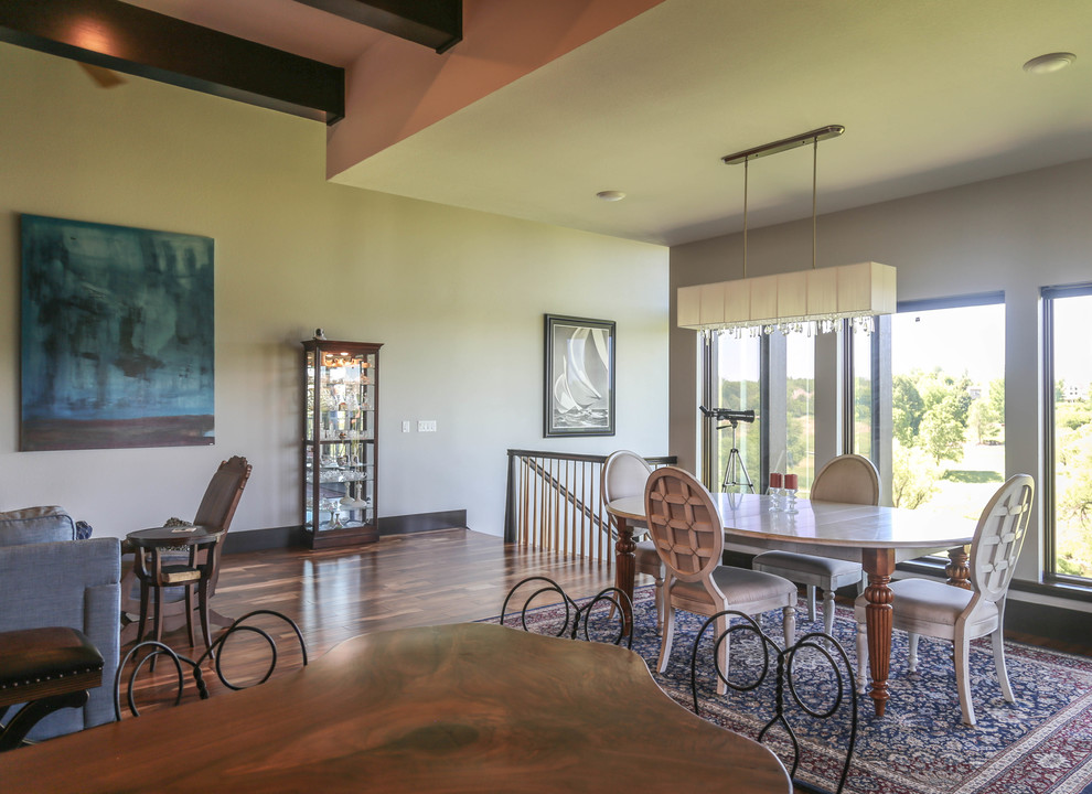 Inspiration for a mid-sized transitional medium tone wood floor and brown floor kitchen/dining room combo remodel with white walls and a standard fireplace