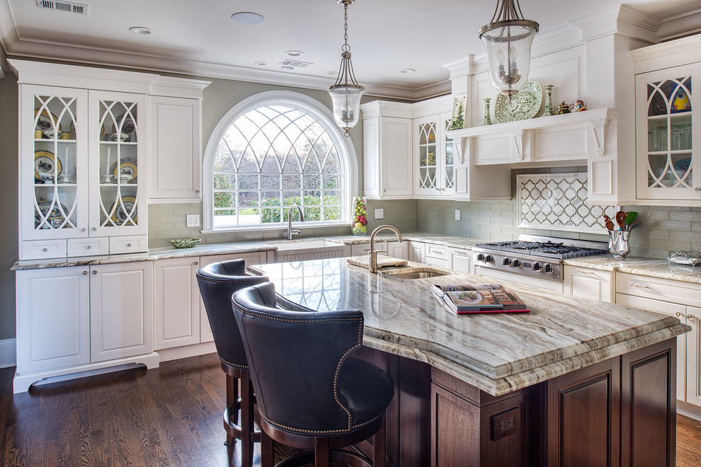Inspiration for a large traditional l-shaped separate kitchen in New York with a farmhouse sink, raised-panel cabinets, white cabinets, granite benchtops, panelled appliances, medium hardwood floors, with island and grey splashback.