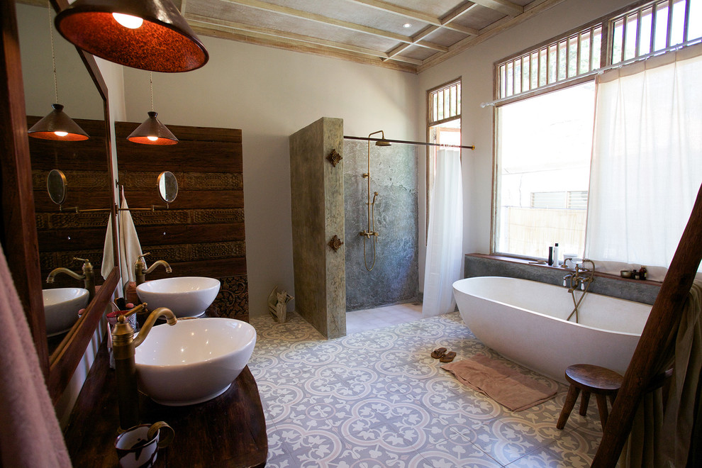 This is an example of an asian master bathroom in Other with a freestanding tub, a curbless shower, beige walls, a vessel sink and a shower curtain.
