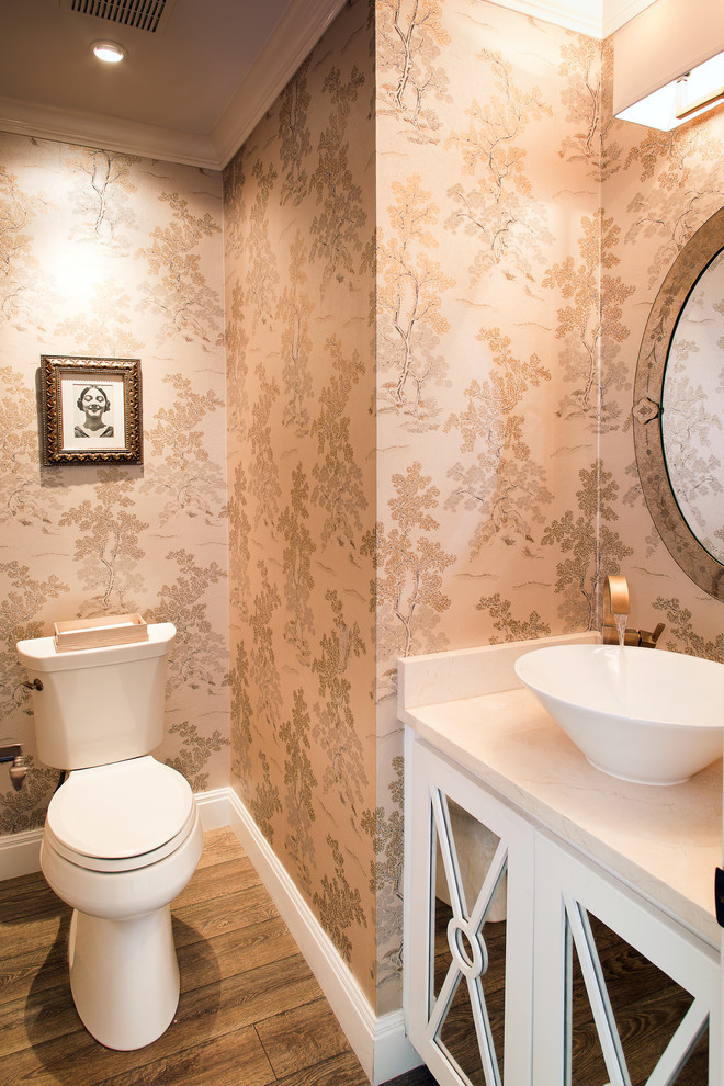 Inspiration for a small timeless 3/4 medium tone wood floor and brown floor bathroom remodel in Austin with raised-panel cabinets, white cabinets, a one-piece toilet, multicolored walls, a vessel sink and quartz countertops