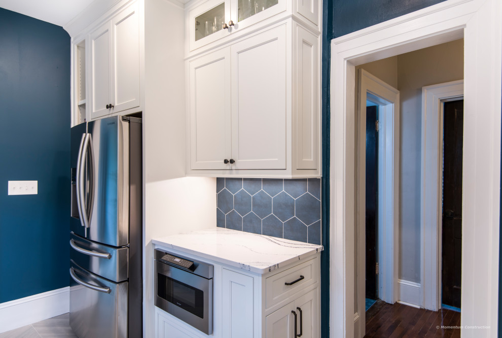 Mid-sized arts and crafts galley kitchen in Atlanta with beaded inset cabinets, white cabinets, quartz benchtops, blue splashback, porcelain splashback, porcelain floors, grey floor and white benchtop.