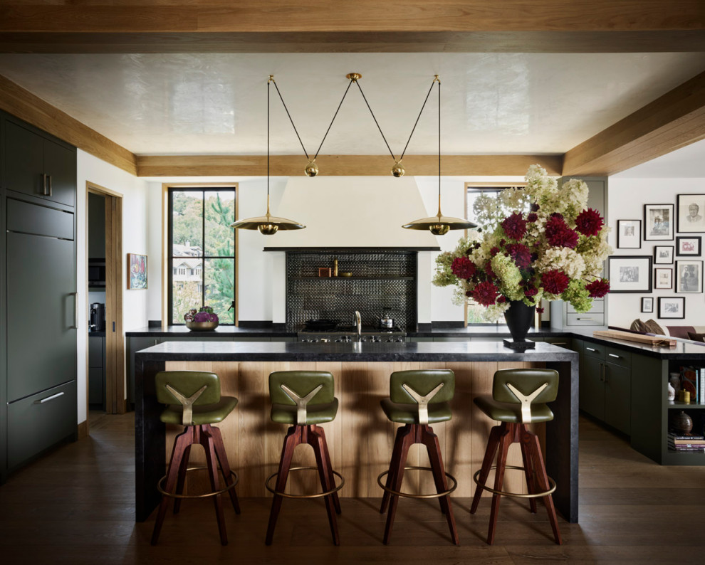 Open concept kitchen - contemporary u-shaped dark wood floor open concept kitchen idea in San Francisco with flat-panel cabinets, black cabinets, black backsplash, paneled appliances, an island and black countertops