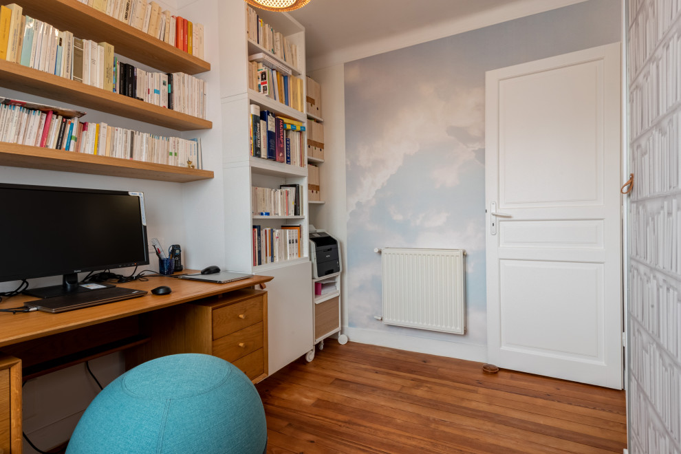 Cette image montre un bureau design de taille moyenne avec un mur blanc, un sol en bois brun, aucune cheminée, un bureau indépendant, un sol marron et du papier peint.