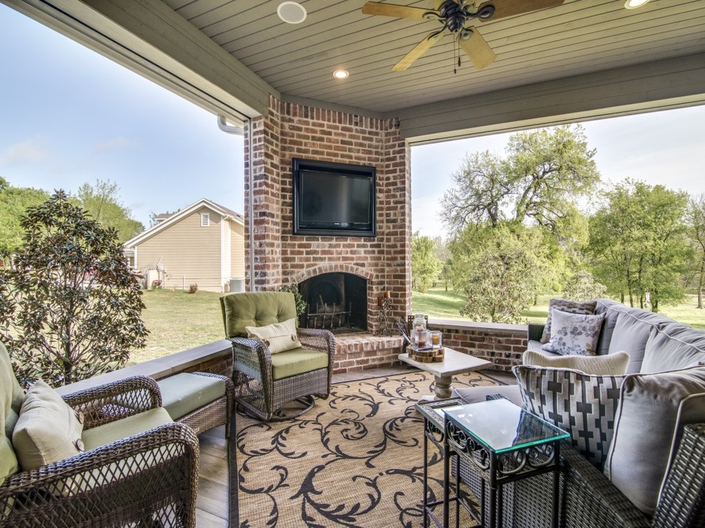 Photo of a mid-sized traditional backyard patio in Dallas with a fire feature, decking and a roof extension.
