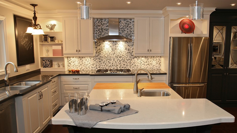 Eat-in kitchen - mid-sized transitional l-shaped medium tone wood floor eat-in kitchen idea with an undermount sink, raised-panel cabinets, white cabinets, quartz countertops, multicolored backsplash, mosaic tile backsplash, stainless steel appliances and an island