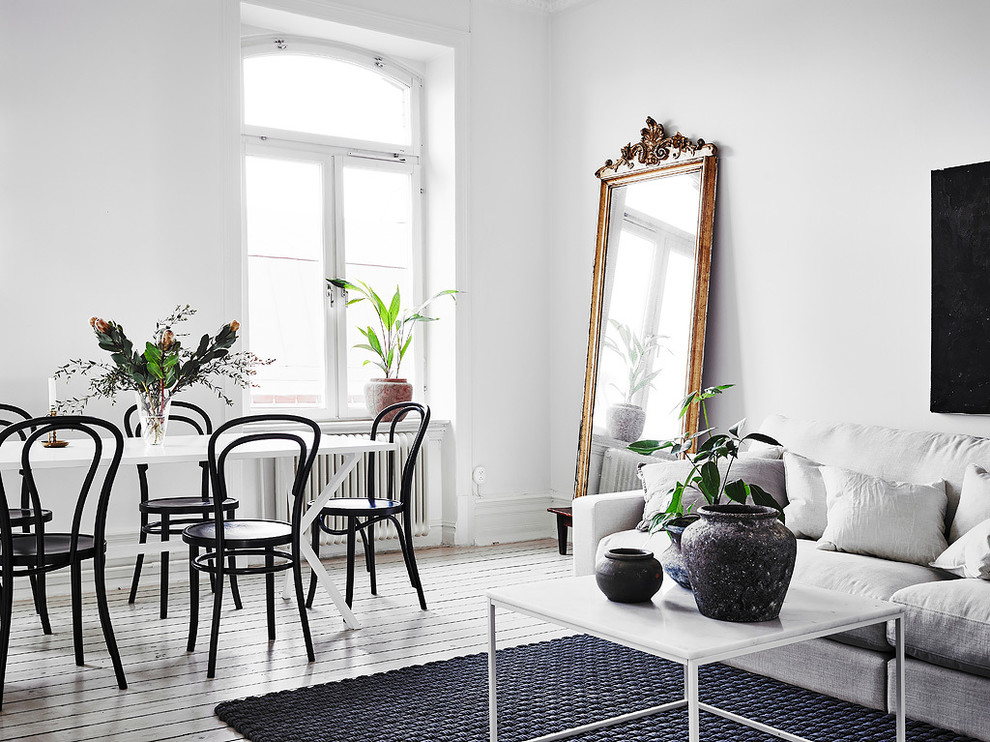 This is an example of a mid-sized scandinavian open plan dining in Gothenburg with white walls, painted wood floors, no fireplace and white floor.