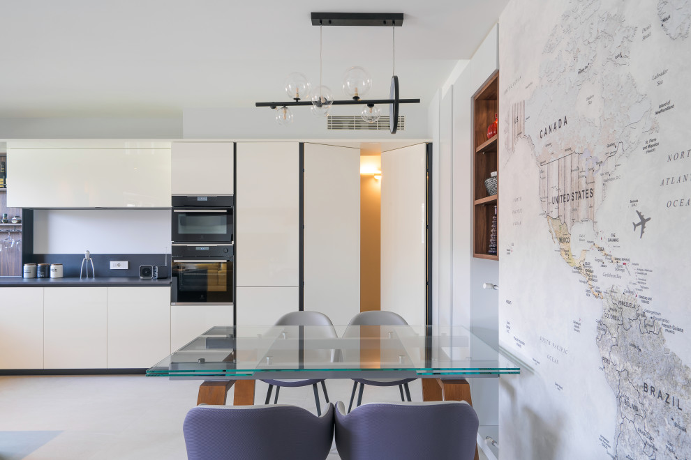 This is an example of a scandinavian u-shaped open plan kitchen in Rome with a peninsula.