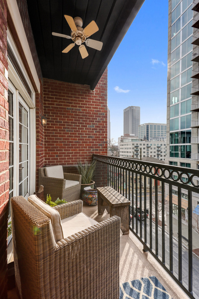 Small contemporary balcony in Atlanta with a roof extension and metal railing.