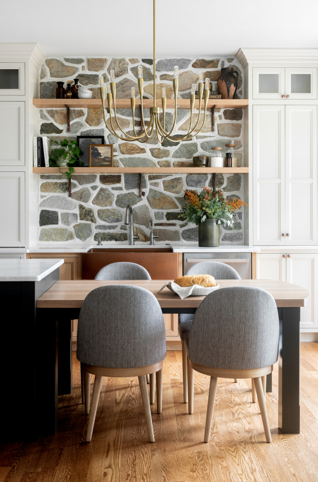 Example of a transitional kitchen design with an island