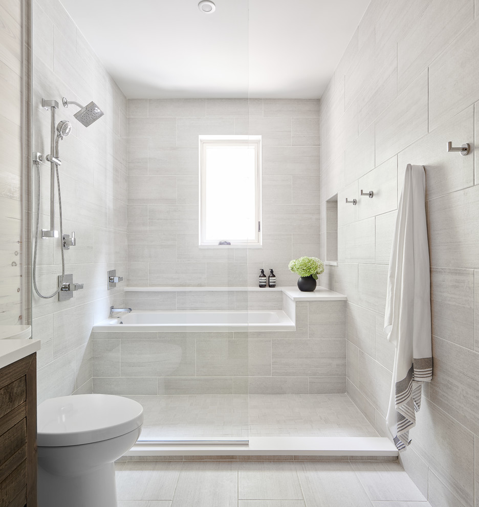 Mid-sized transitional master wet room bathroom in Toronto with flat-panel cabinets, dark wood cabinets, a drop-in tub, a one-piece toilet, gray tile, porcelain tile, white walls, porcelain floors, solid surface benchtops, white floor, an open shower and white benchtops.