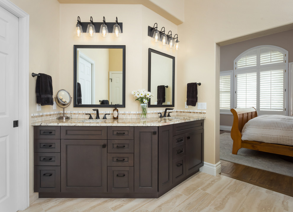 This is an example of a mid-sized transitional master bathroom in Denver with flat-panel cabinets, grey cabinets, a freestanding tub, an alcove shower, a one-piece toilet, beige tile, stone tile, beige walls, an undermount sink, granite benchtops, beige floor, a hinged shower door and beige benchtops.