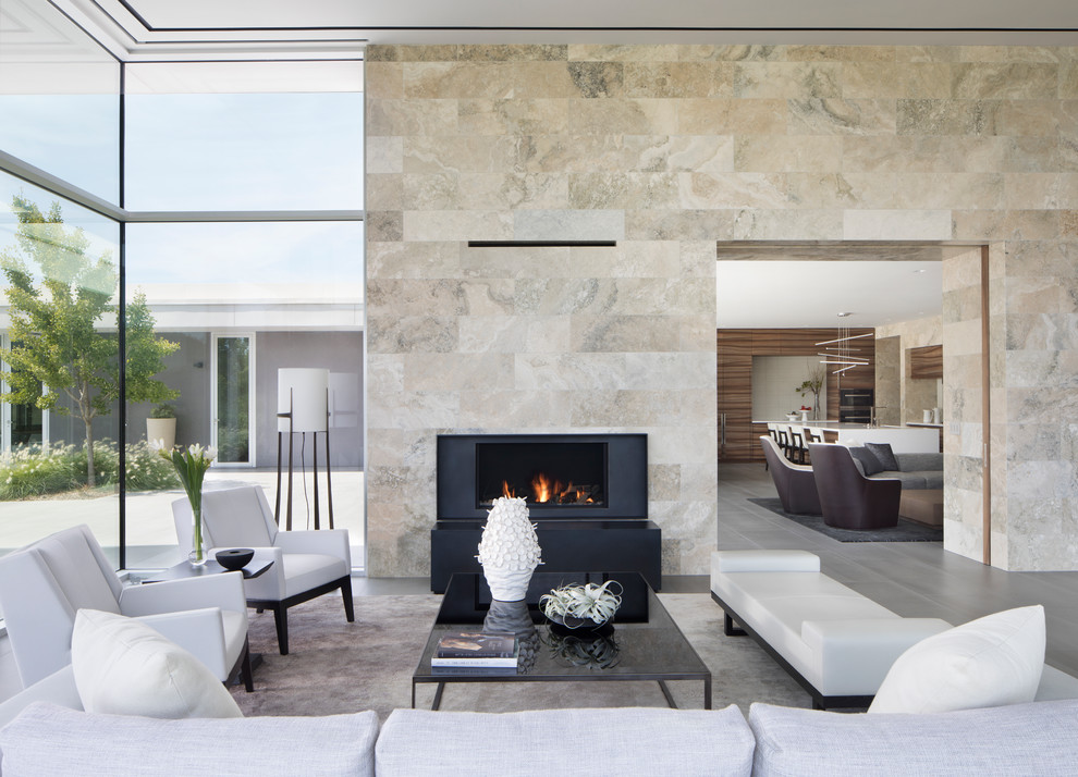 Large contemporary formal open concept living room in San Francisco with beige walls, porcelain floors, a standard fireplace, grey floor, a stone fireplace surround and no tv.