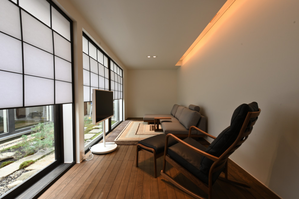 Photo of a medium sized grey and brown enclosed living room in Other with beige walls, medium hardwood flooring, no fireplace, brown floors, a timber clad ceiling and tongue and groove walls.
