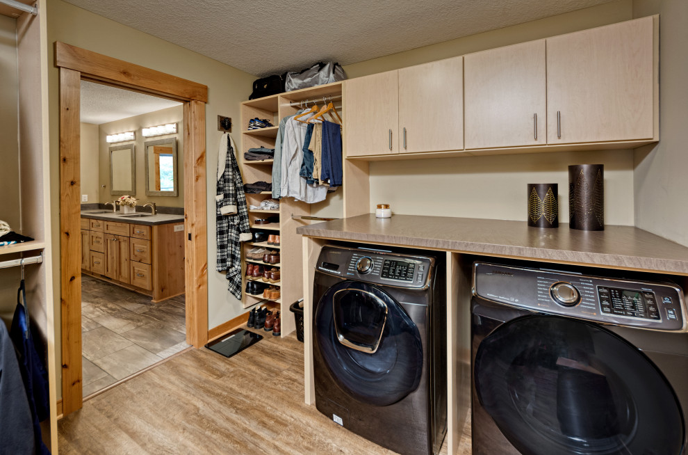 Mid-sized arts and crafts laundry room in Minneapolis with flat-panel cabinets, light wood cabinets, vinyl floors and multi-coloured floor.
