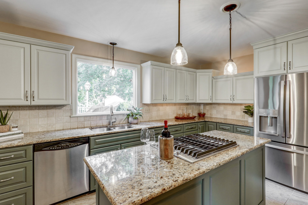 Example of a mid-sized transitional l-shaped ceramic tile and beige floor eat-in kitchen design with a double-bowl sink, raised-panel cabinets, green cabinets, granite countertops, beige backsplash, ceramic backsplash, stainless steel appliances, an island and beige countertops