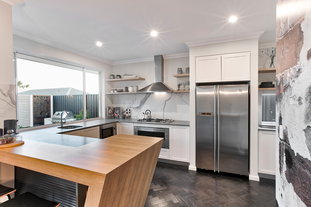 Design ideas for a mid-sized contemporary u-shaped separate kitchen in Perth with a single-bowl sink, white cabinets, white splashback, stainless steel appliances, shaker cabinets, stone slab splashback, dark hardwood floors, no island, brown floor and black benchtop.