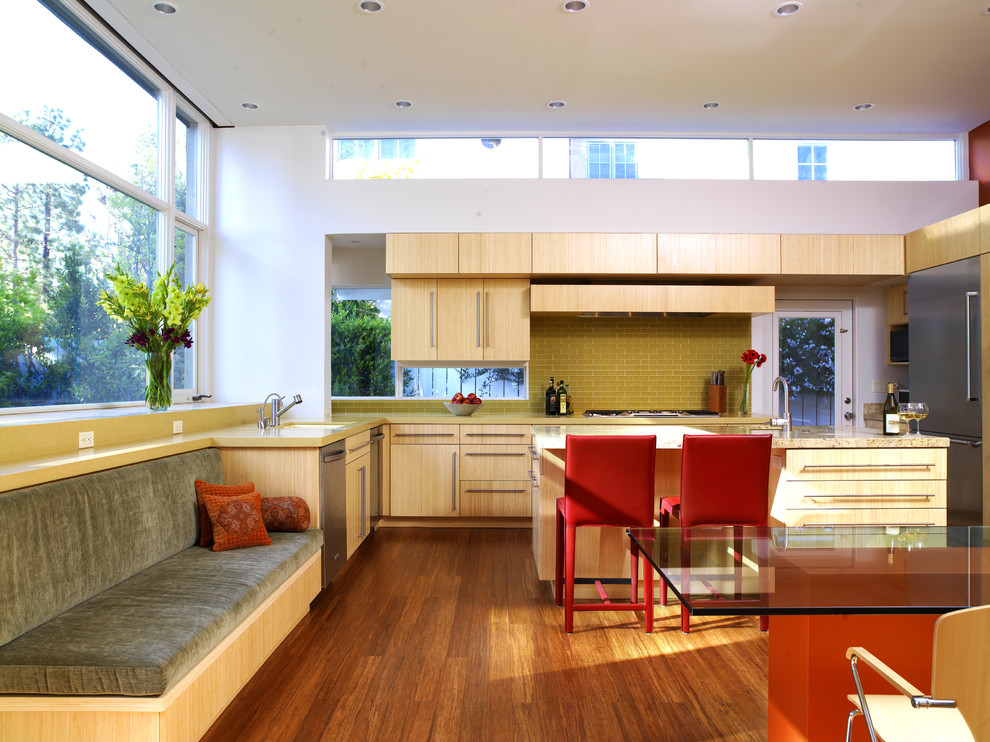 Large contemporary u-shaped separate kitchen in Los Angeles with an undermount sink, flat-panel cabinets, light wood cabinets, quartzite benchtops, green splashback, glass tile splashback, stainless steel appliances, bamboo floors and with island.