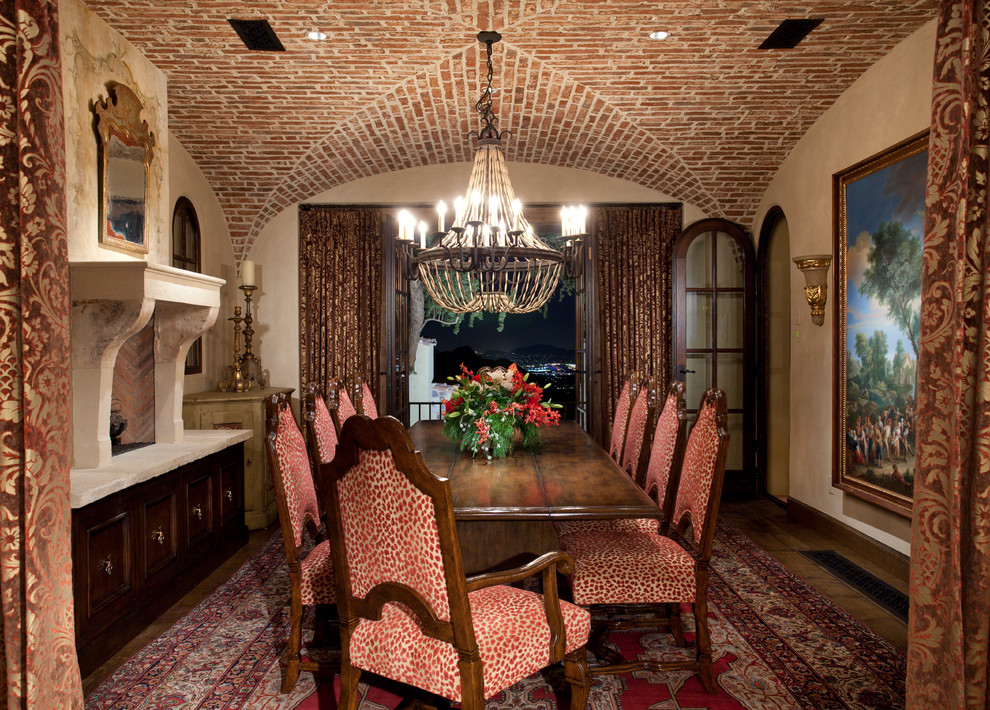 Mediterranean separate dining room in Phoenix with beige walls and dark hardwood floors.