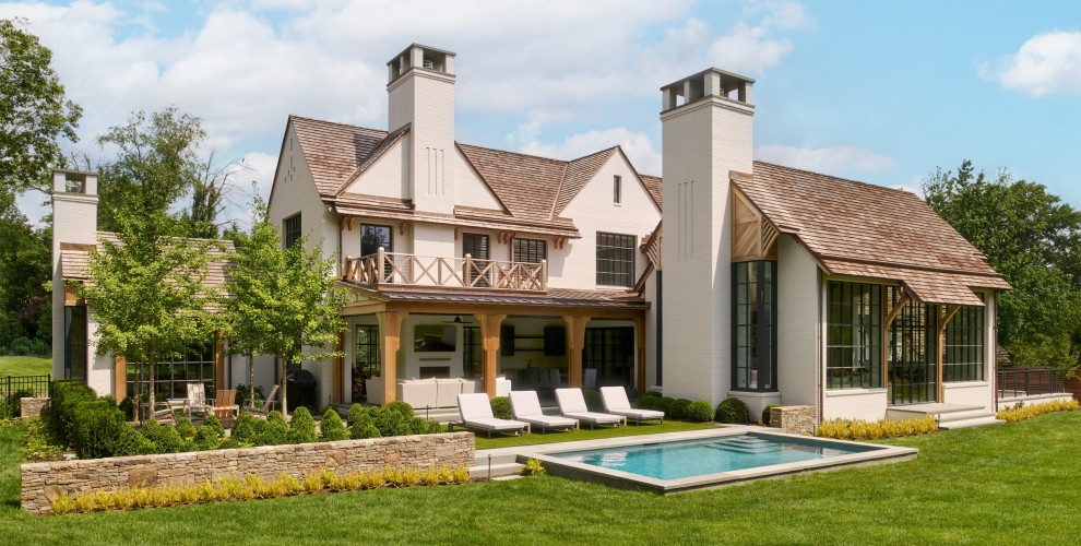 Transitional beige two-story brick house exterior idea in Philadelphia with a shingle roof