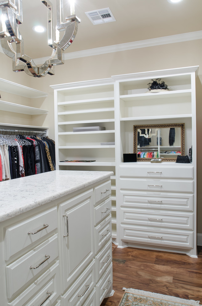 Large mediterranean gender-neutral walk-in wardrobe in Austin with open cabinets, white cabinets, dark hardwood floors and brown floor.