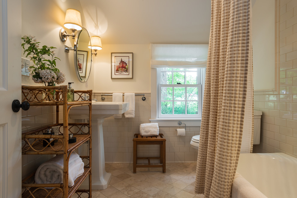 Photo of a traditional bathroom in New York with a pedestal sink and subway tile.