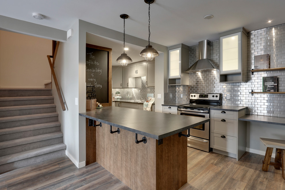 Inspiration for a small country u-shaped eat-in kitchen in Calgary with a double-bowl sink, shaker cabinets, grey cabinets, laminate benchtops, metallic splashback, metal splashback, stainless steel appliances, medium hardwood floors and a peninsula.
