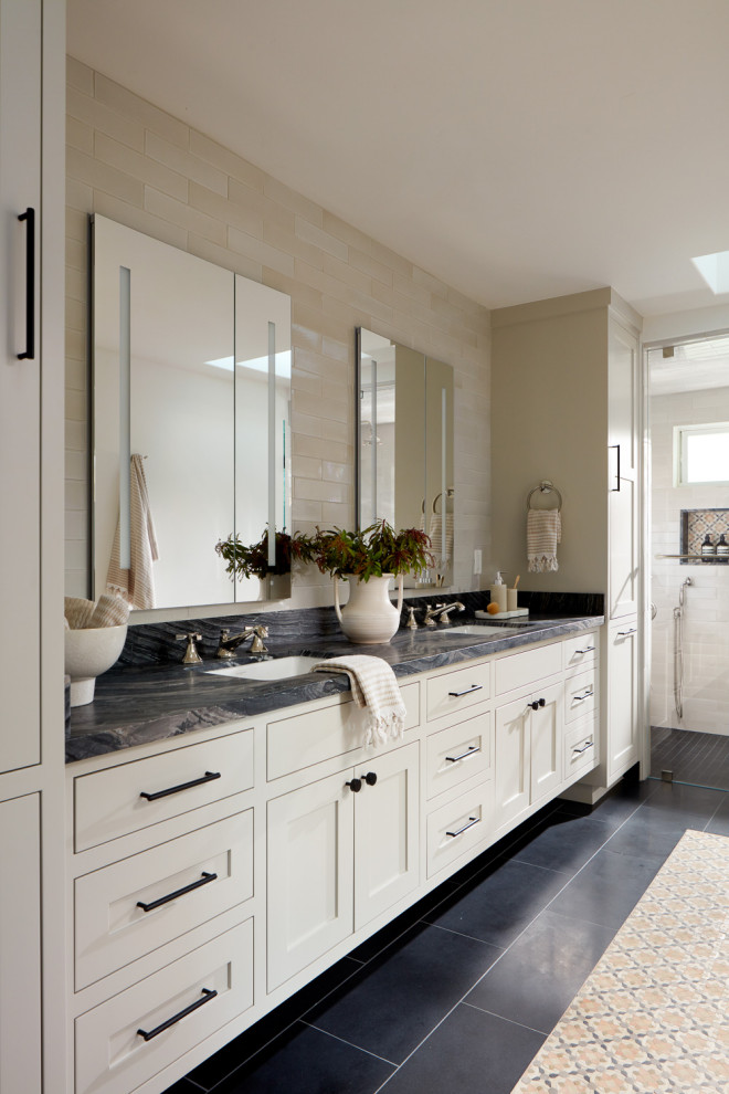 Design ideas for a transitional bathroom in San Francisco with shaker cabinets, white cabinets, a curbless shower, beige tile, an undermount sink, black floor, a hinged shower door, grey benchtops, a niche, a double vanity and a built-in vanity.