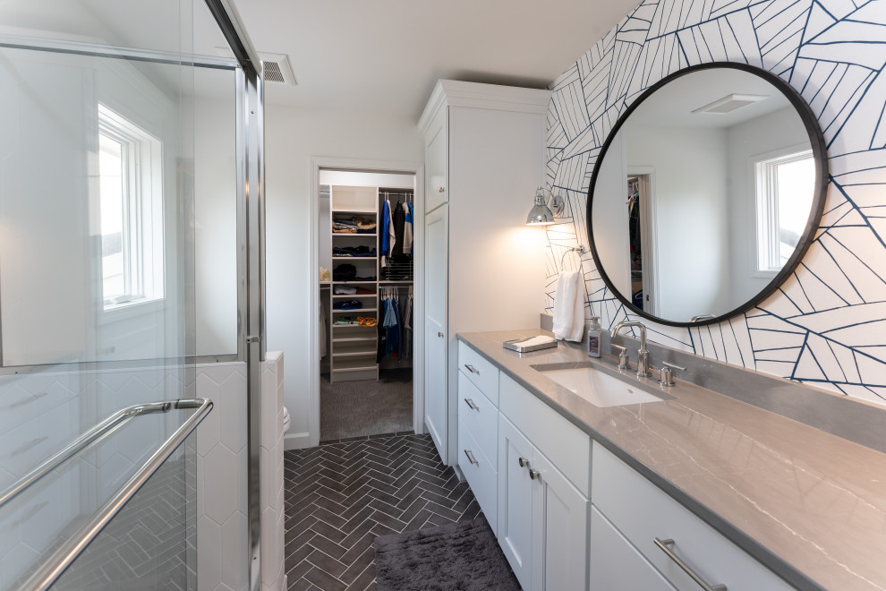 Mid-sized transitional kids bathroom in Kansas City with shaker cabinets, white cabinets, a corner shower, white walls, ceramic floors, an undermount sink, engineered quartz benchtops, black floor, a sliding shower screen, grey benchtops, a single vanity, a built-in vanity and wallpaper.