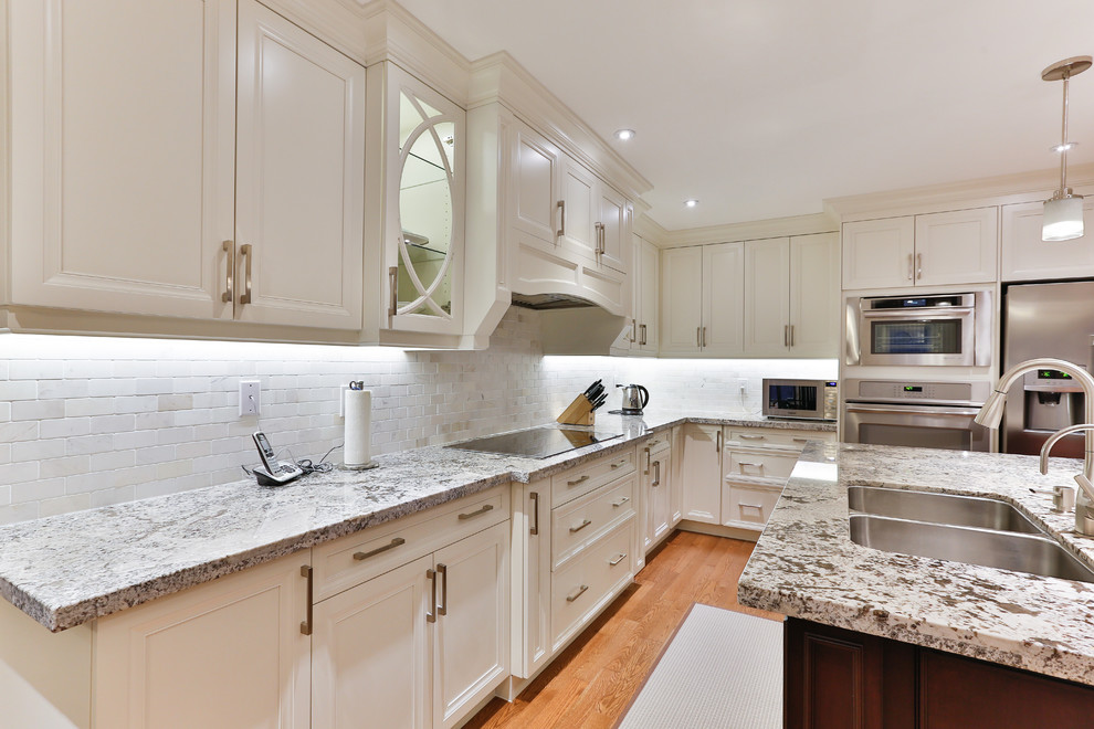 Example of a transitional kitchen design in Toronto