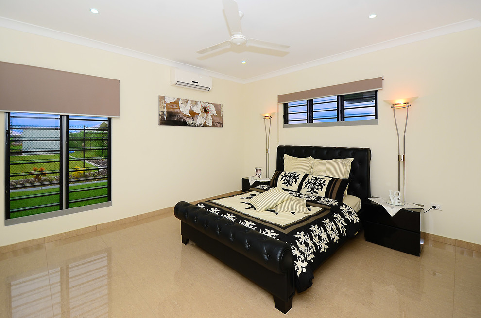 This is an example of a large contemporary master bedroom in Darwin with beige walls, porcelain floors and no fireplace.