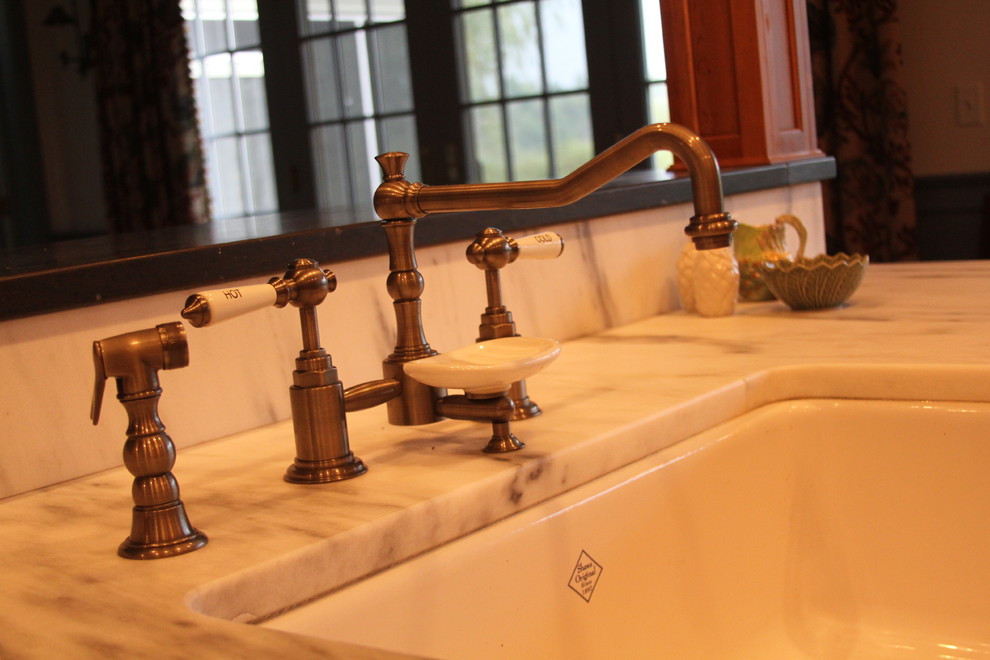 Large transitional galley eat-in kitchen photo in Boston with a farmhouse sink, raised-panel cabinets, medium tone wood cabinets, marble countertops, stainless steel appliances and a peninsula