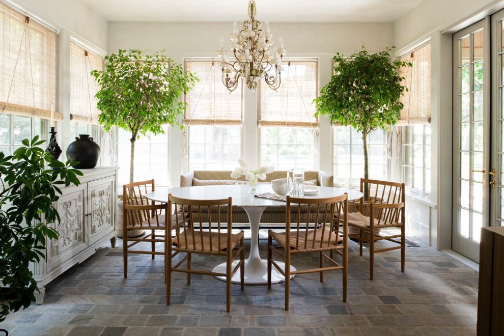 This is an example of a dining room in Minneapolis with limestone floors.