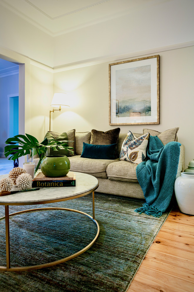 This is an example of a mid-sized eclectic open concept living room in Sydney with carpet, a freestanding tv and blue floor.