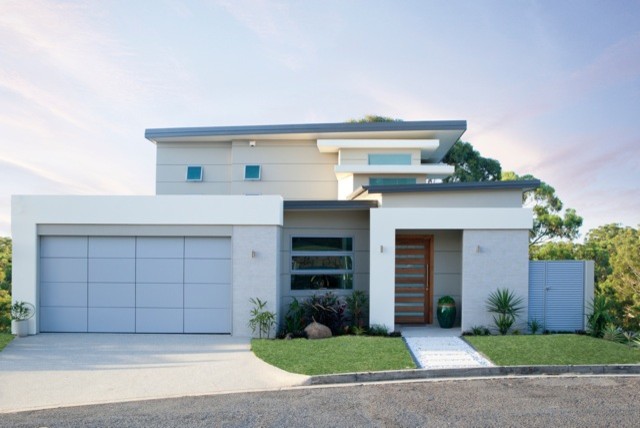 Inspiration for a large contemporary three-storey beige exterior in Gold Coast - Tweed with mixed siding and a flat roof.