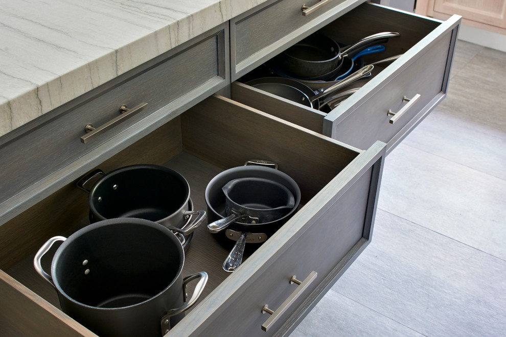 Inspiration for a large transitional u-shaped porcelain tile eat-in kitchen remodel in New York with a farmhouse sink, recessed-panel cabinets, light wood cabinets, quartzite countertops, gray backsplash, ceramic backsplash, paneled appliances and an island