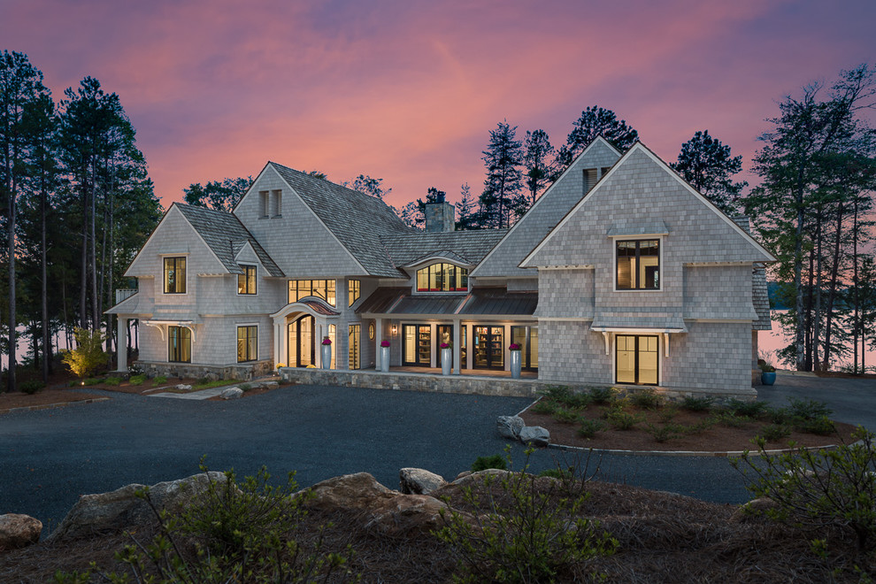Example of a huge transitional gray two-story gable roof design