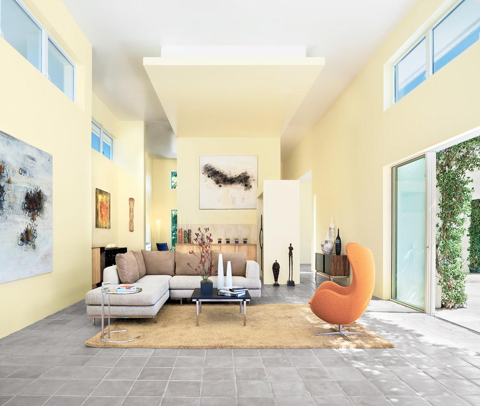 Design ideas for a large contemporary open concept living room in Tampa with yellow walls and terra-cotta floors.