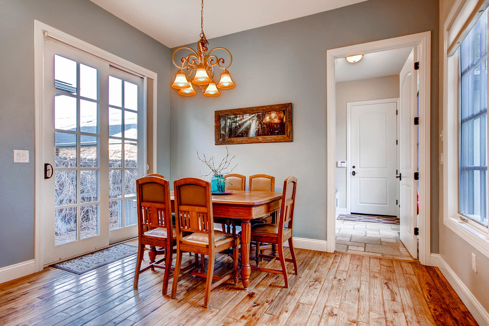 Inspiration for a mid-sized transitional medium tone wood floor enclosed dining room remodel in Denver with gray walls and no fireplace