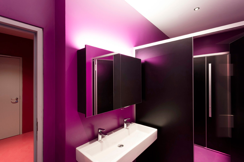 Large contemporary powder room in Stuttgart with a two-piece toilet, multi-coloured tile, purple walls and a trough sink.